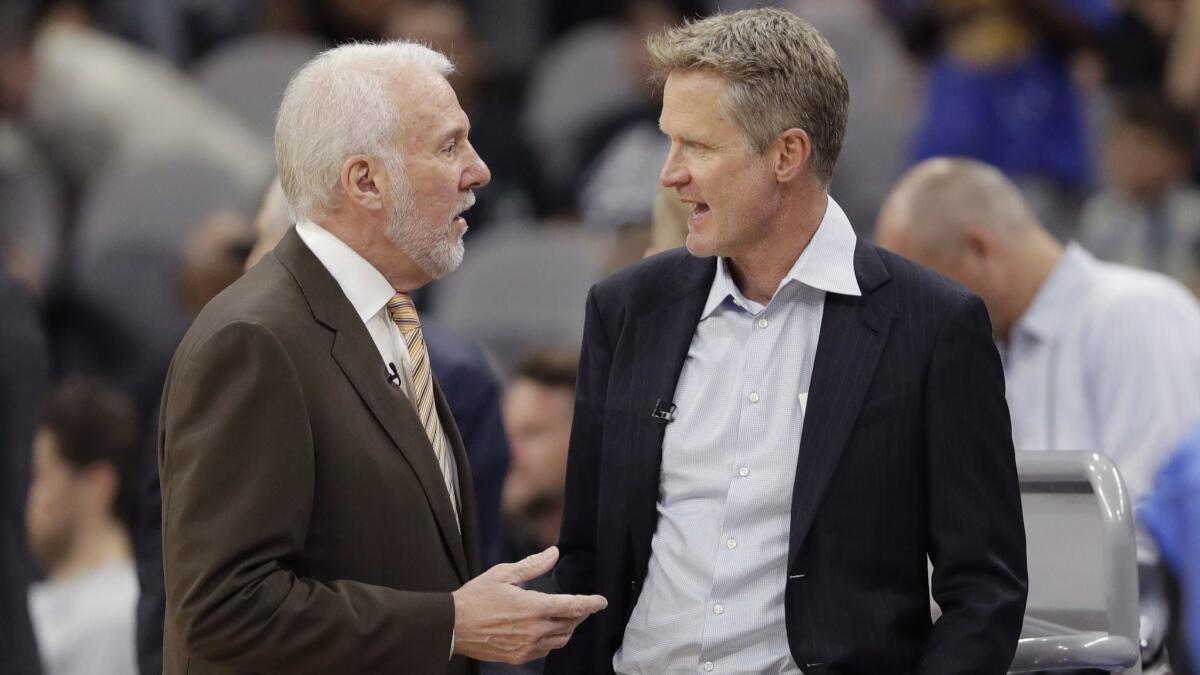 San Antonio Spurs coach Gregg Popovich, left, and Golden State Warriors coach Steve Kerr visit before a game on Nov. 2.