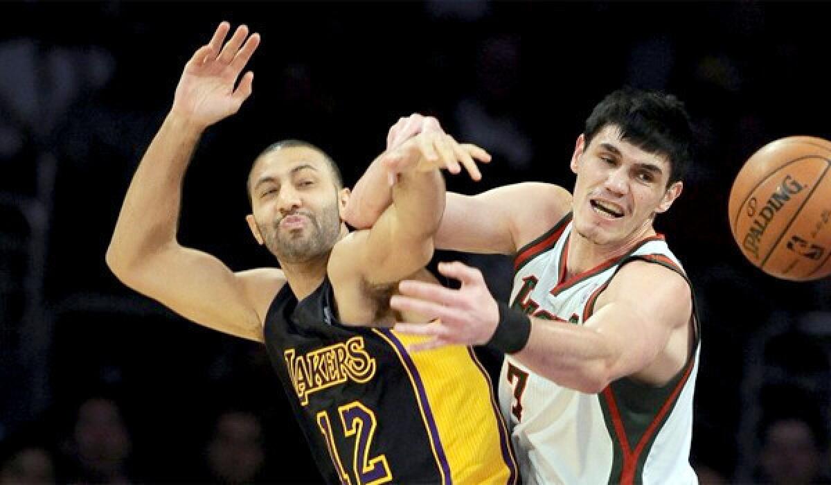 Kendall Marshall and Milwaukee's Ersan Ilyasova fight for a rebound on Dec. 31. Marshall became a starter after the injuries forced the Lakers to sign the former first-round draft pick of the Phoenix Suns.