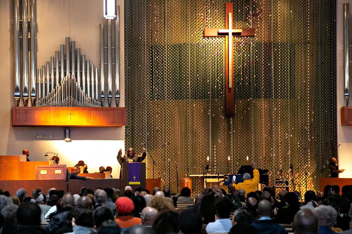 Apostle Beverly Crawford offers spiritual support to Mark Ridley-Thomas.