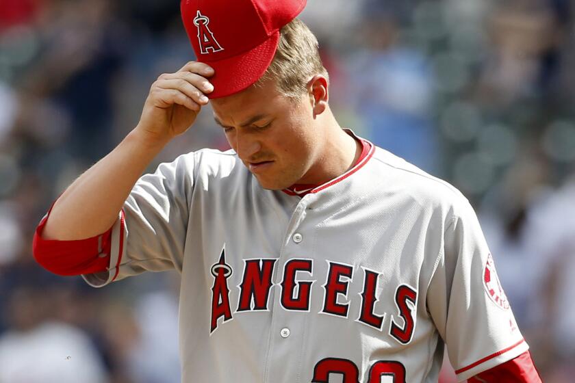 Angels reliever Joe Smith reacts after giving up a solo home run to Minnesota's Oswaldo Arcia during the eighth inning Saturday.