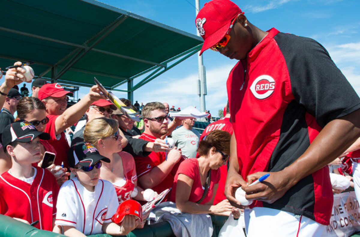 Reds closer Aroldis Chapman signs autographs for fans before an exhibition game against the Cleveland Indians last month in Goodyear, Ariz.