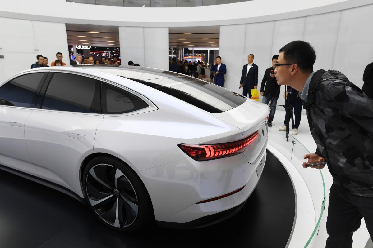 A visitor looks at NIO's ET Preview sedan at the Shanghai Auto Show in April.