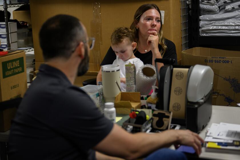 LA VERNE, CA - SEPTEMBER 16, 2024: Jacob and Lindsay Dunn with their son Bodhi, 2, own Sow Eden Organics, a CBD-hemp product company September 16, 2024 in La Verne, California. Gov. Gavin Newsom is proposing regulations that would immediately render illegal much of the industry and the products it creates. The Dunns are concerned the new regulations will cost them lots of money and might put them out of business.(Gina Ferazzi / Los Angeles Times)