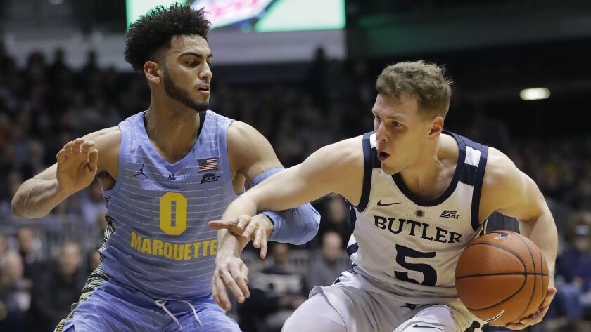 Butler's Paul Jorgensen (5) is defended by Marquette's Markus Howard (0) during the first half.