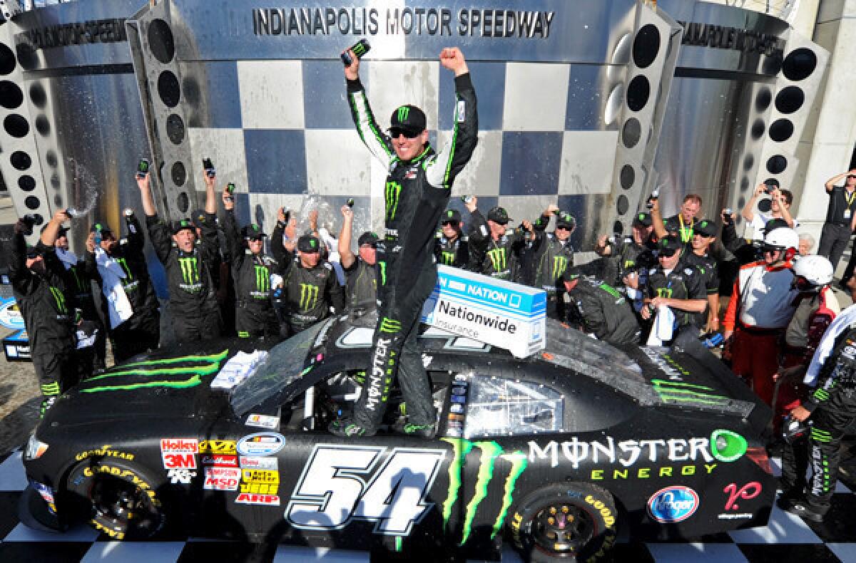 Kyle Busch celebrates after winning the NASCAR Nationwide Series Indiana 250 race at Indianapolis Motor Speedway on Saturday.