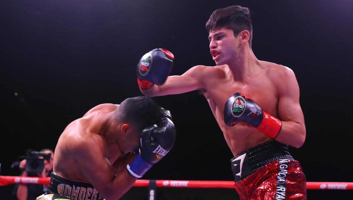 Ryan Garcia, right, throws a punch during his victory over Jose Lopez on March 30.