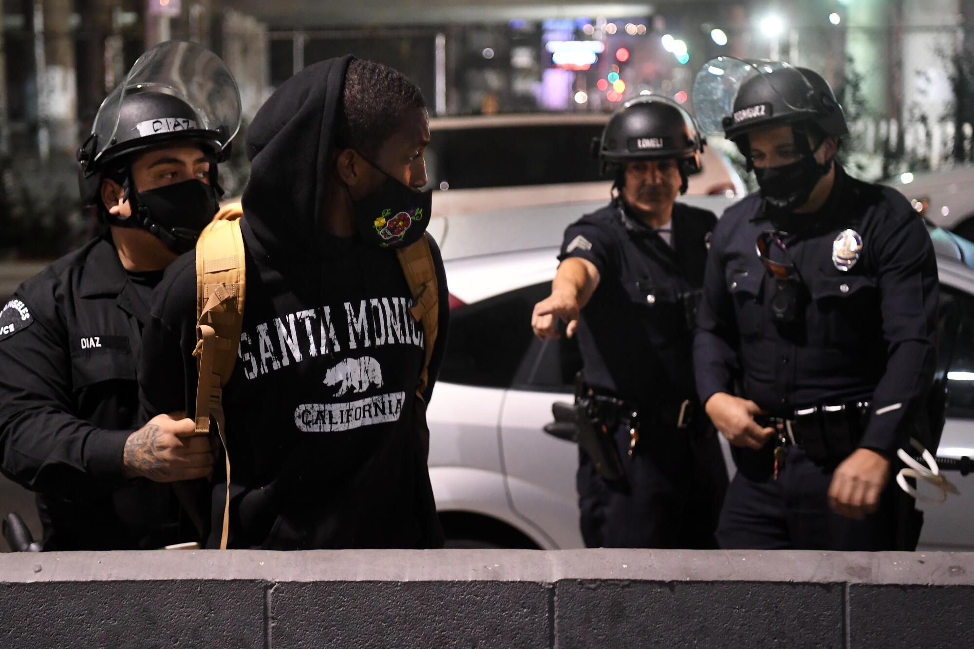 LAPD officers arrest a protester on Figueroa Street in downtown Los Angeles on election night.
