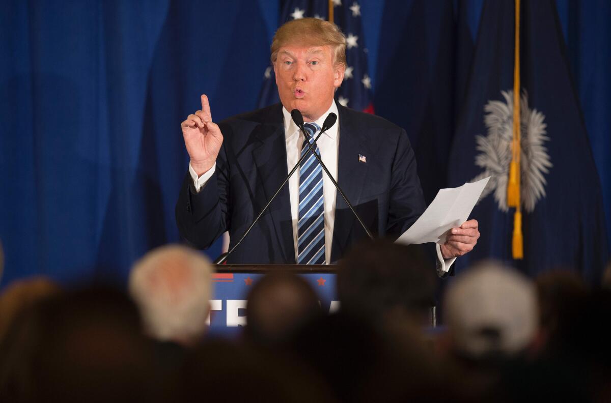 Republican presidential candidate Donald Trump reads from a statement about Pope Francis during a campaign rally in Kiawah, S.C., on Thursday.