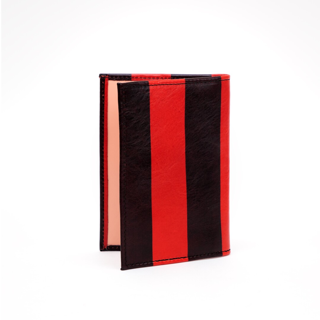 A red-and-black-striped passport case.