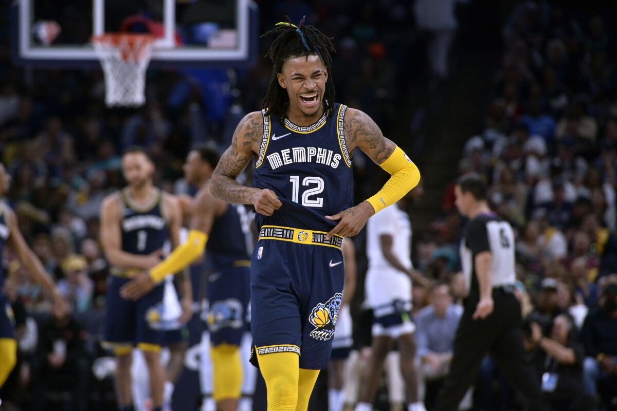 Memphis Grizzlies guard Ja Morant (12) reacts during the second half of Game 2 of a first-round NBA basketball playoff series against the Minnesota Timberwolves on Tuesday, April 19, 2022, in Memphis, Tenn. (AP Photo/Brandon Dill)
