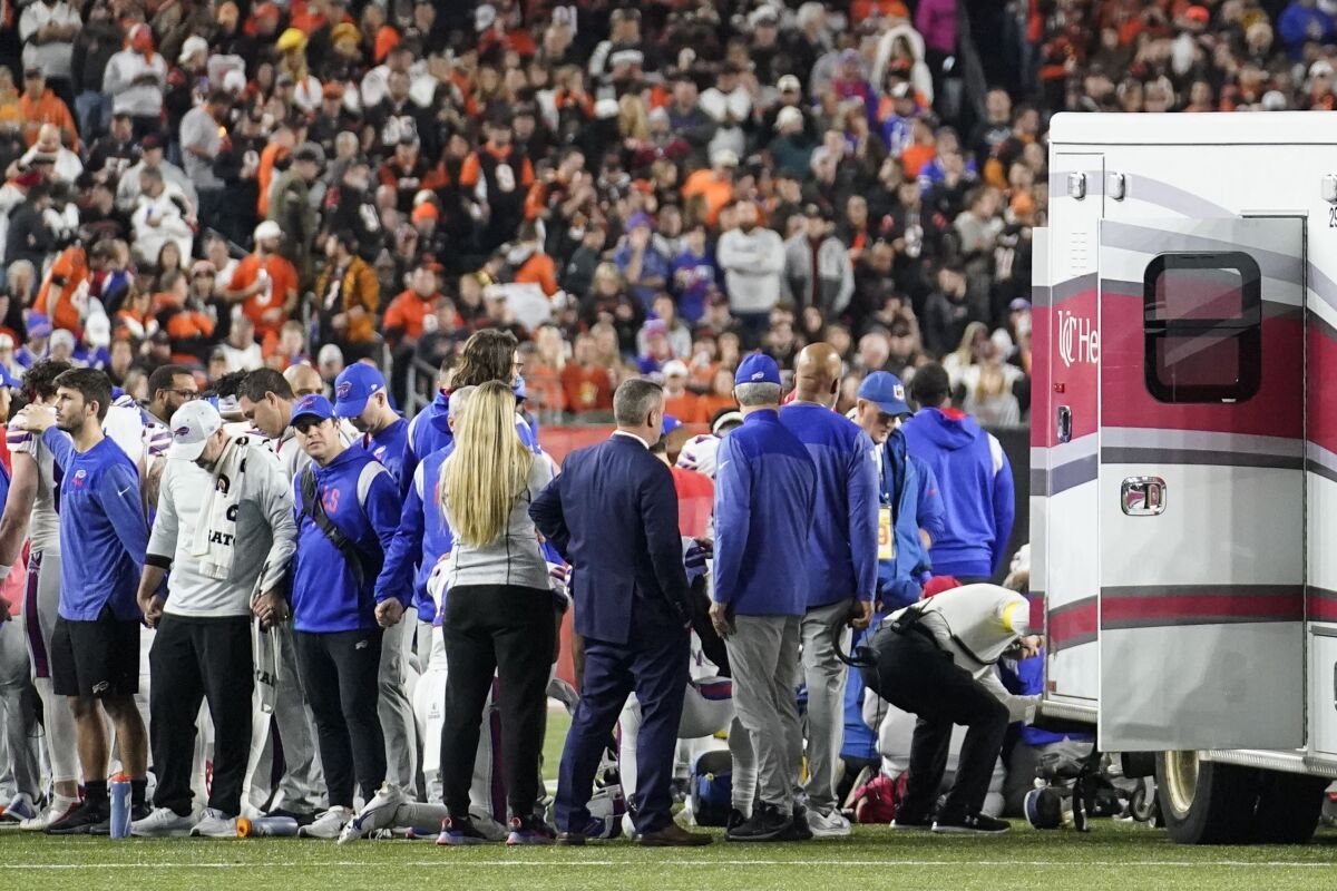 Players and staff on the field after Damar Hamlin's collapse.