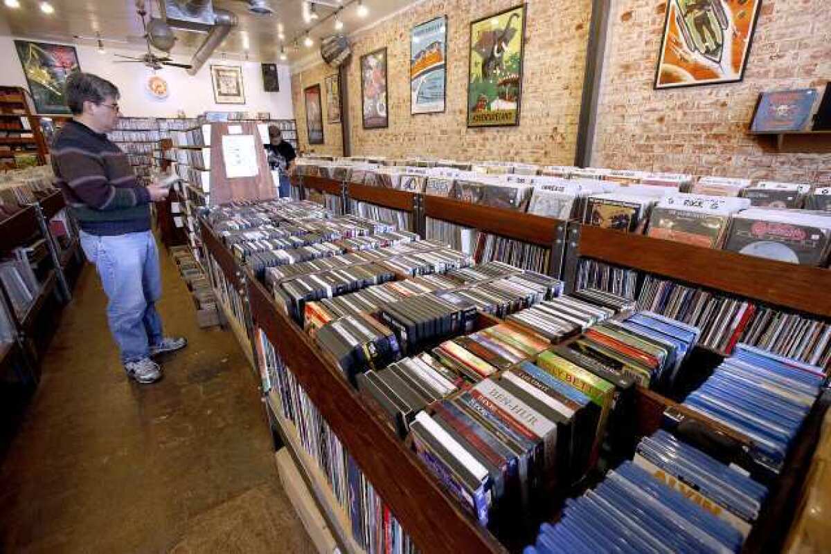 A customer looks through movies at Atomic Records in Burbank on Wednesday, March 6, 2013.