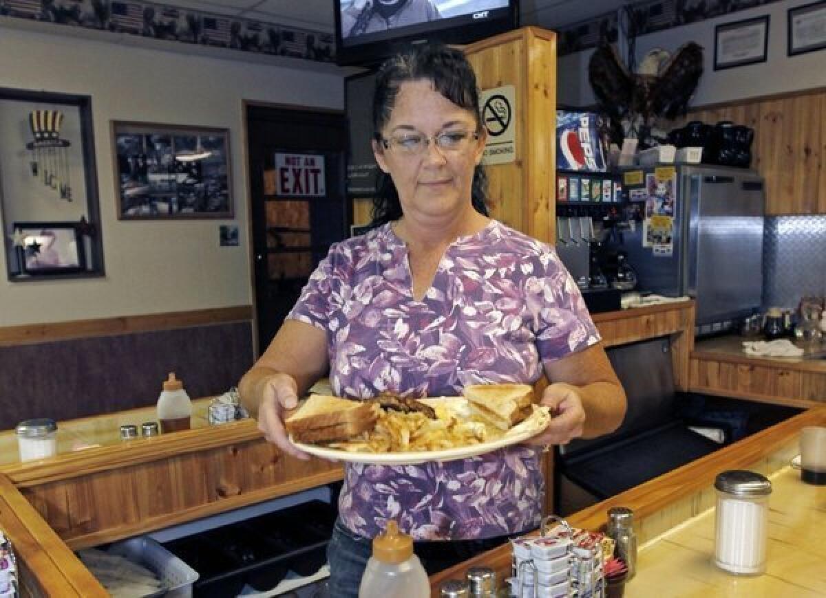 Millie Brown, a cook and waitress at Buch's truck stop, serves a breakfast in Steubenville, Ohio.