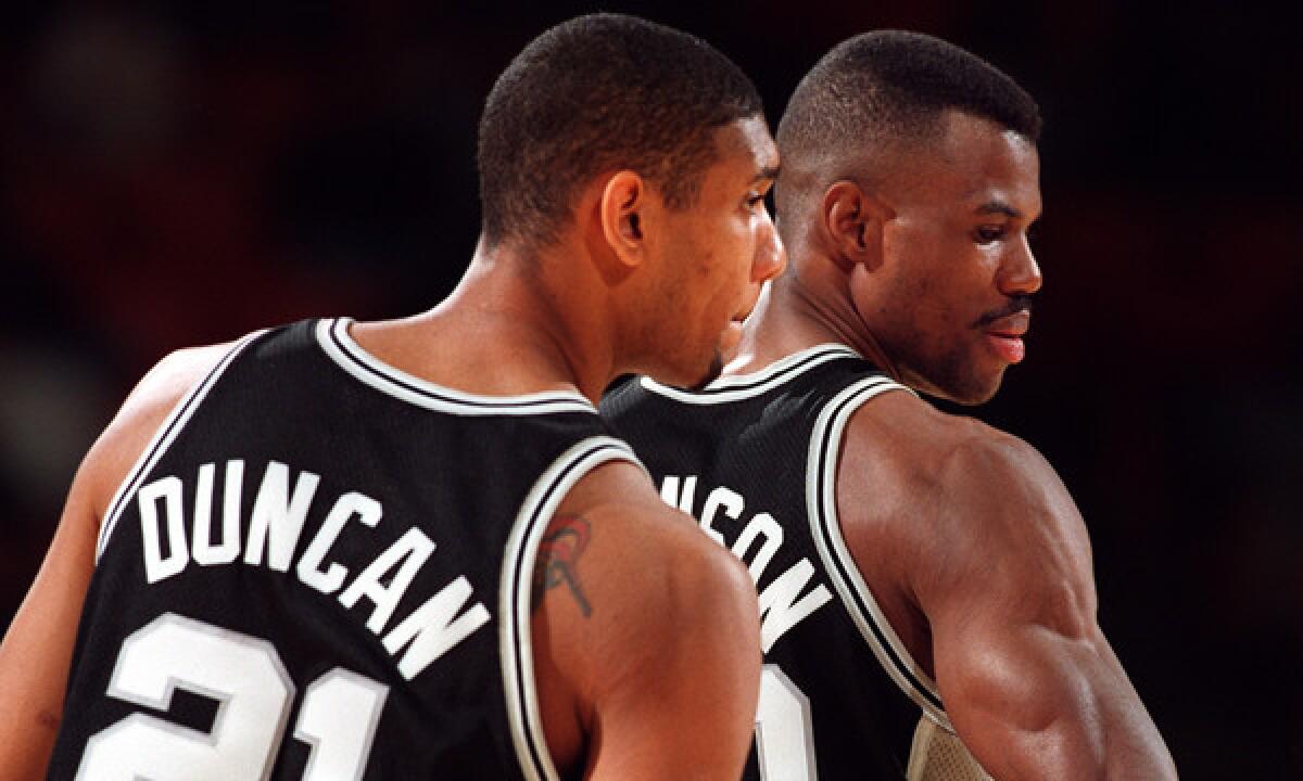 The San Antonio Spurs' dreadful 1996-97 season allowed them to draft Tim Duncan, left, in 1997 to help complement veteran leader David Robinson, right. San Antonio has won four NBA titles during Duncan's tenure with the team.