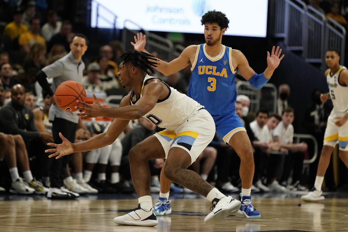 Marquette's Justin Lewis loses the ball in front of UCLA's Johnny Juzang during the second half Dec. 11, 2021.
