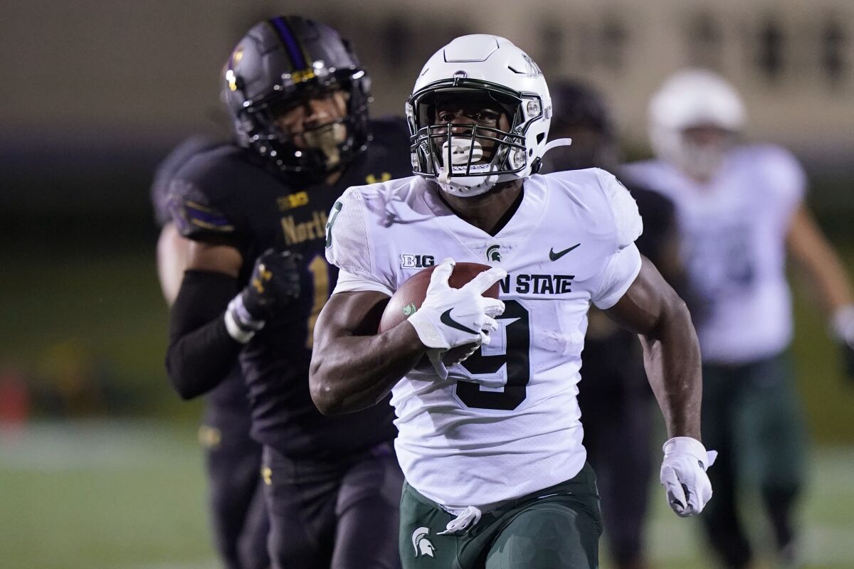 Michigan State running back Kenneth Walker III (9) runs for a touchdown past Northwestern safety Brandon Joseph (16) during the first half of an NCAA college football game in Evanston, Ill., Friday, Sept. 3, 2021. (AP Photo/Nam Y. Huh)