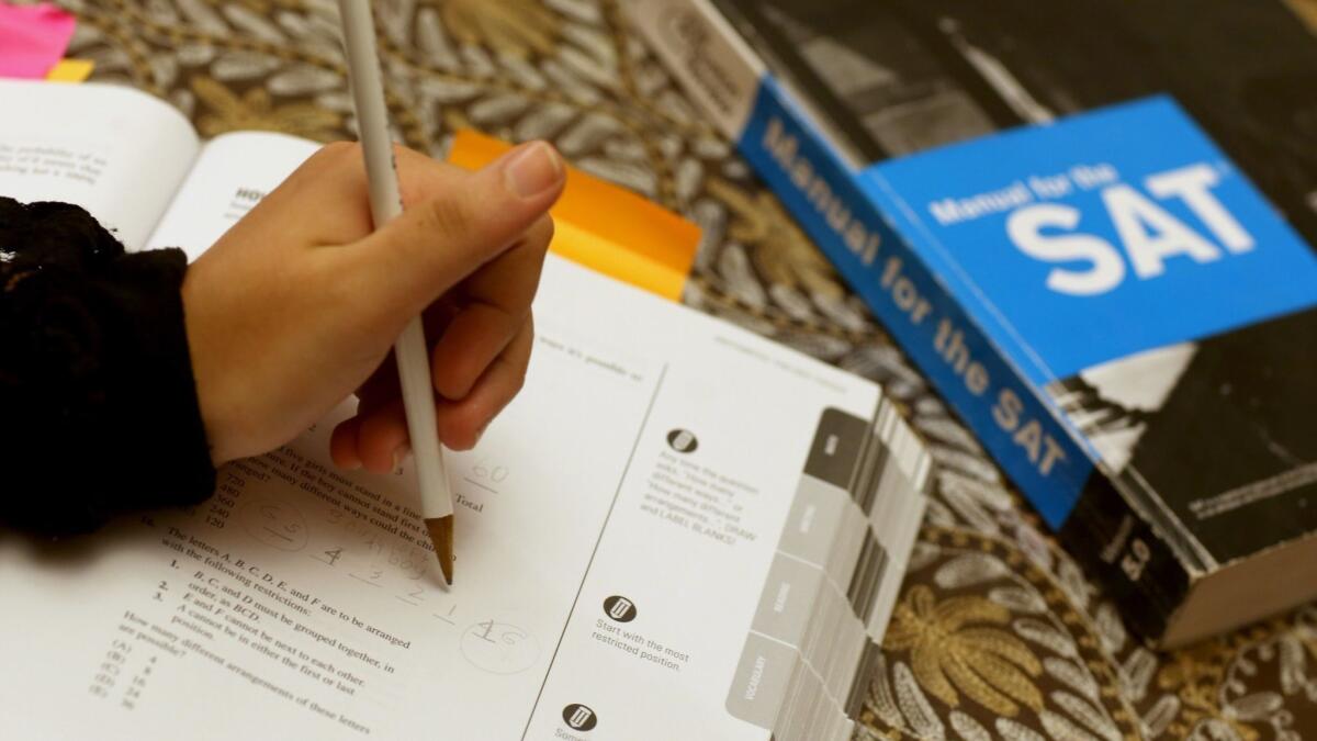 A student uses a test preparation guide to study for the SAT.