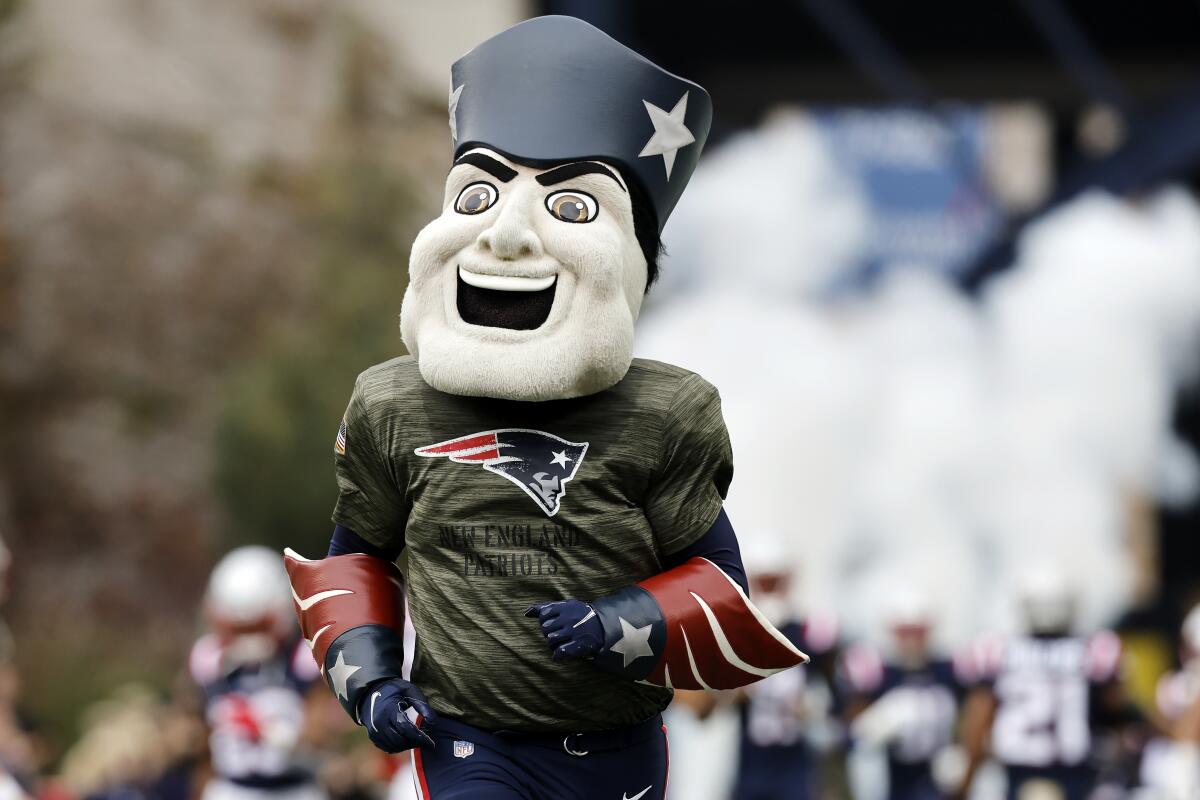 The New England Patriots mascot walks around the field before an NFL football game 