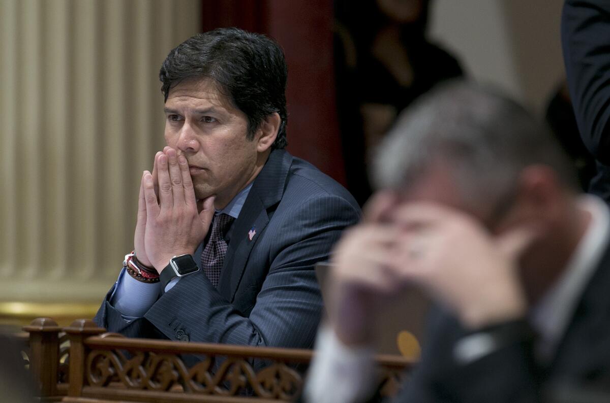 Then-Senate President Pro Tem Kevin de León sits with his hands pressed together in front of his mouth. 