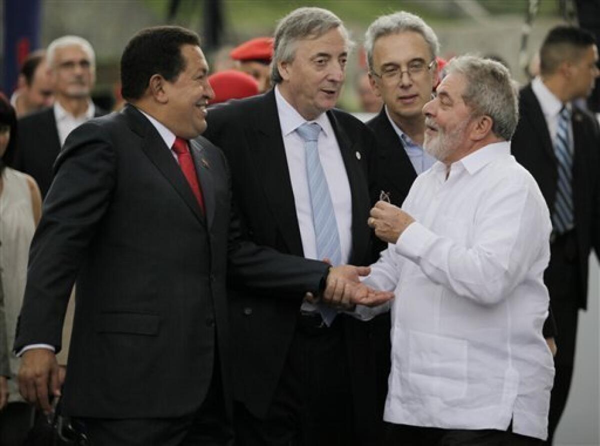 FILE - In this Aug. 6, 2010 file photo, Union of South American Nations (UNASUR) Secretary General Nestor Kirchner, second from left, speaks with Venezuela's President Hugo Chavez, left, and Brazil's President Luiz Inacio Lula da Silva, right, at Miraflores presidential palace in Caracas, Venezuela. According to state television in Argentina, Nestor Kirchner died on Wednesday Oct. 27, 2010 of a heart attack at age 60. (AP Photo/Ariana Cubillos, File)