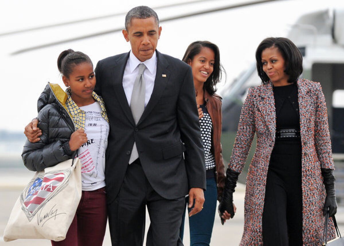 President Obama, First Lady Michelle Obama, and their daughters Malia and Sasha, board Air Force One at Chicago O'Hare International Airport in Chicago, Ill.