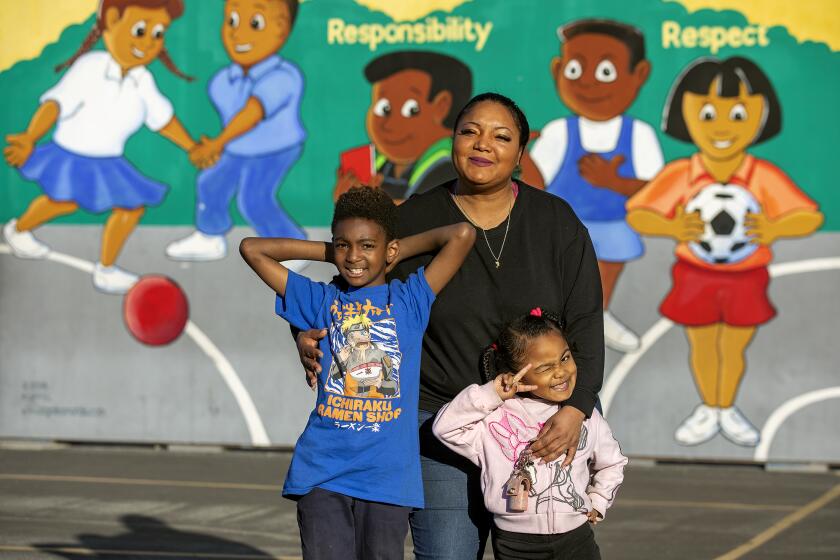LOS ANGELES, CA-FEBRUARY 3, 2023:Antoinnyca Daniels, 36, who lives in a shelter in South Los Angeles with her son Aiden Abiy, 8, and daughter Amore Daniels, 4, is photographed with her kids at Compton Ave. Elementary School STEAM Academy in Los Angeles, where her son attends and is in the 3rd grade. Her daughter is in pre-school at 112th St. School in Los Angeles. (Mel Melcon / Los Angeles Times)