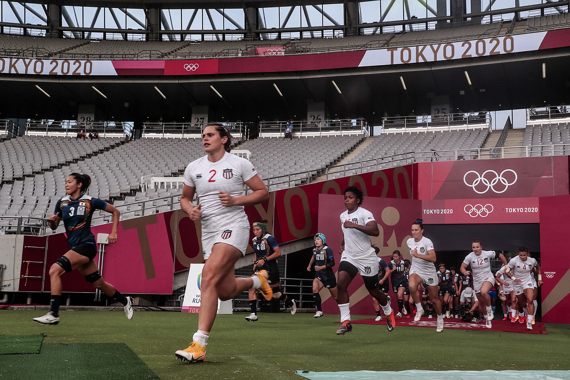 Team USA and Japan run onto the field for a Tokyo 2020 Olympics Women's Rugby Sevens game