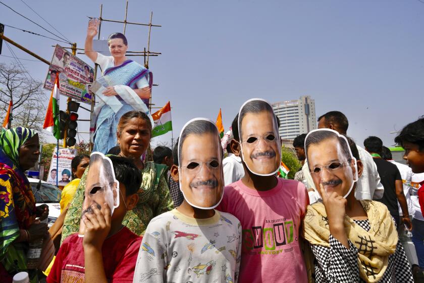 Supporters of the Aam Admi Party wear masks in the likeness of the party leader and Delhi Chief Minister Arvind Kejriwal at a protest rally organized by INDIA bloc, a group formed by opposition parties, in New Delhi, India, Sunday, March 31, 2024. Protesters are demanding the release of the top elected official of New Delhi who was arrested on March 21 in a liquor bribery case. (AP Photo/Manish Swarup)