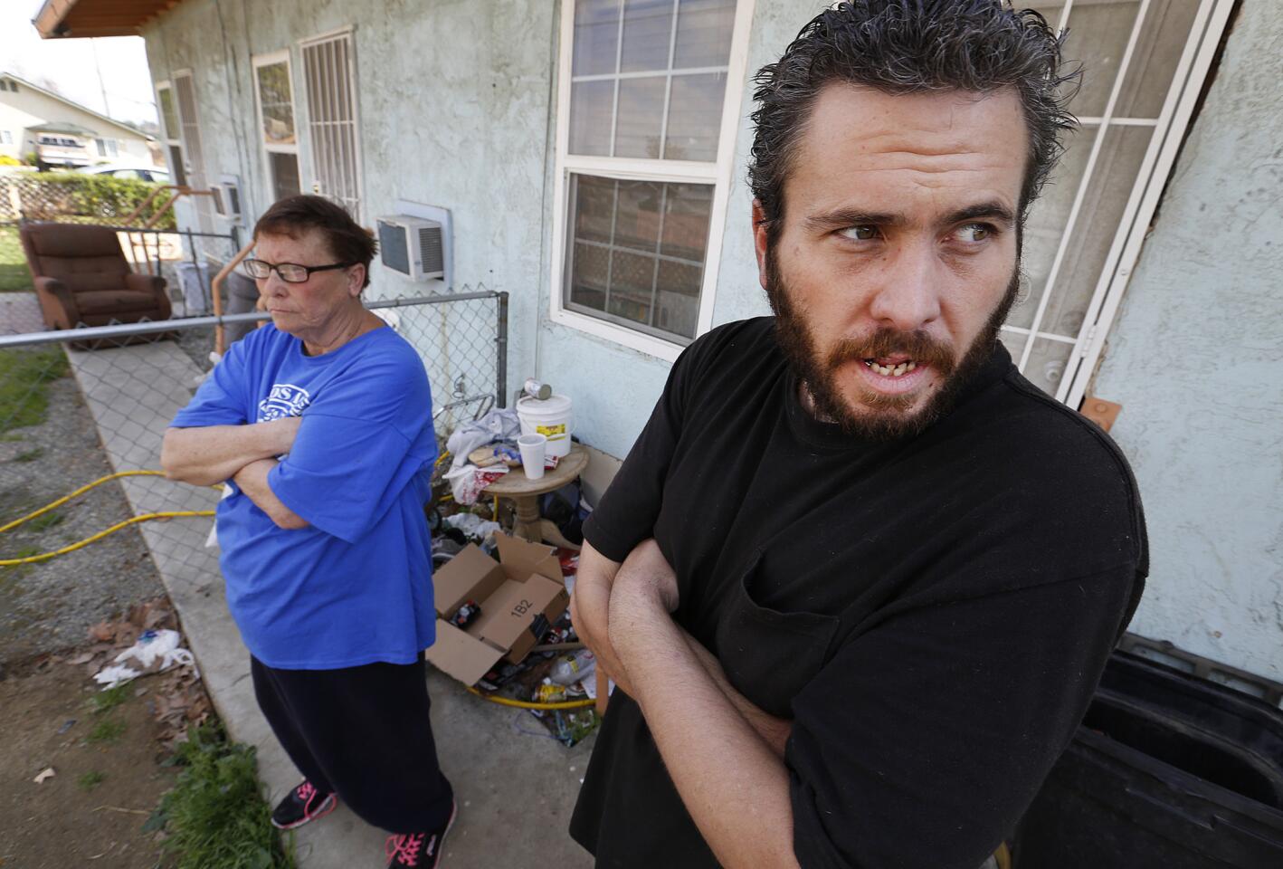 Betty Robison, left, who supports Donald Trump, debates with her 31-year-old son Sean Kearns about the GOP front-runner as they stand in the front yard of their apartment in Oildale, an unincorporated community in Kern County.