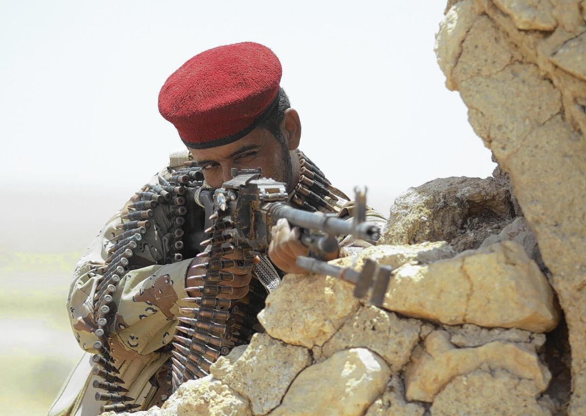 An Iraqi Shiite Muslim fighter takes position outside the Shiite holy city of Najaf, 100 miles south of Baghdad.