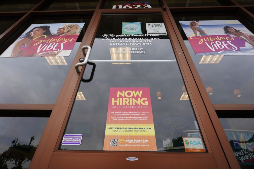 A Now Hiring sign at a business in Richmond, Va., Wednesday, June 2, 2021. U.S. employers posted a record 9.3 million job openings in April as the U.S. economy reopens at break-neck speed. Openings were up 12% from 8.3 million in March. (AP Photo/Steve Helber)
