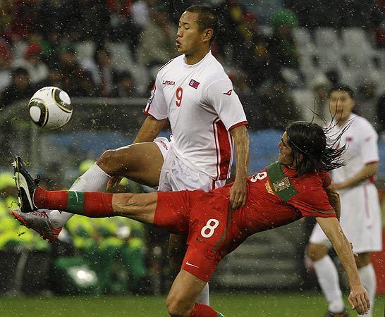 North Korea's Jong Tae-se (9) competes for the ball with Portugal's Pedro Mendes during a World Cup Group G match in Cape Town, South Africa, on Monday.
