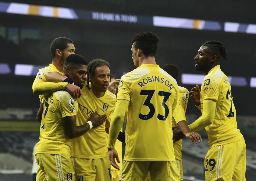 Fulham's Ivan Cavaleiro celebrates with teammates after scoring his side's opening goal during the English Premier League soccer match between Tottenham Hotspur and Fulham at the Tottenham Hotspur Stadium in London, Wednesday, Jan. 13, 2021. (Glyn Kirk/Pool via AP)