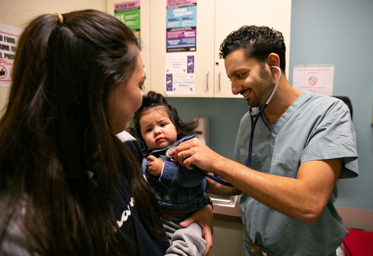 Dr. David Bolour works in his office at St. John's Well Child and Family Center in South Los Angeles. Bolour tests every child he treats for elevated lead levels.