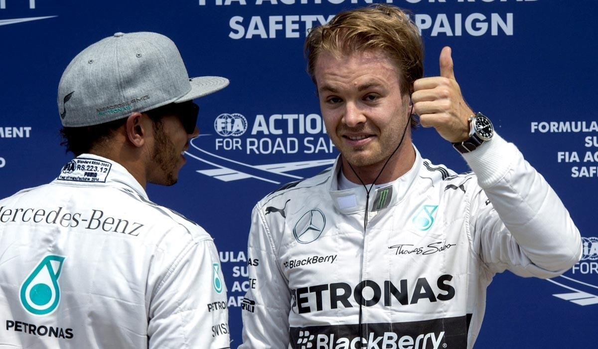 Formula One driver Nico Rosberg gives the thumbs-up Saturday as he's congratulated by Mercedes teammate Lewis Hamilton after winning the pole position for the Canadian Grand Prix. Hamilton qualified second for Sunday's race.