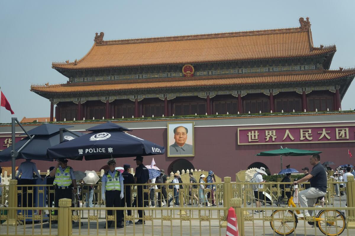 Police officers watch over Tiananmen Gate in Beijing.