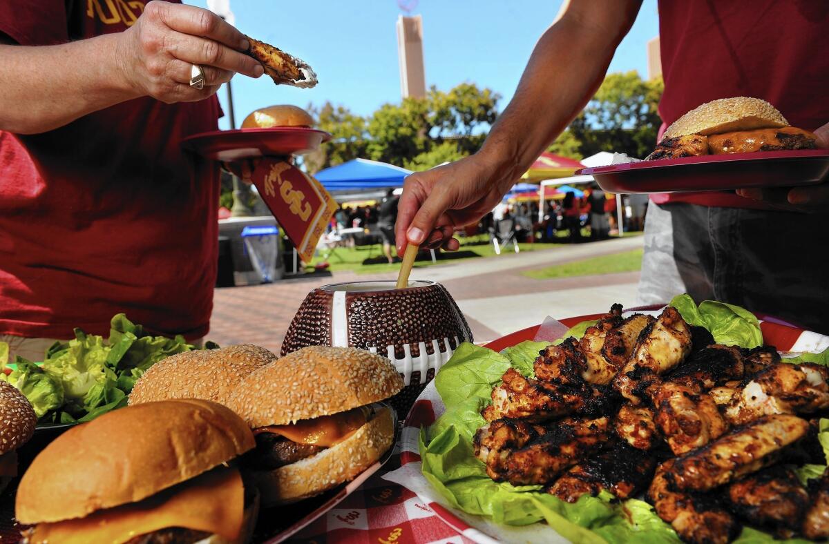 Burgers and chipotle chicken wings are perfect for a tailgate party at the Coliseum.