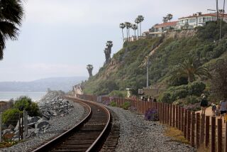 SAN CLEMENTE, CA - APRIL 28: Railroad tracks and hillside along the Beach Trail on Friday, April 28, 2023 in San Clemente, CA. Rail service remained unavailable in southern Orange County today due to a landslide that damaged the historic Casa Romantica Cultural Center and Gardens and sent dirt and debris cascading down a hillside toward coastal railroad tracks. (Gary Coronado / Los Angeles Times)