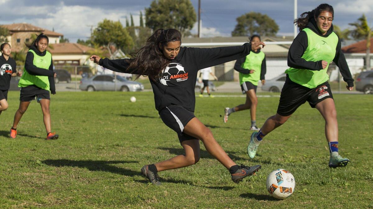 Los Amigos High’s Ariana Figueroa, center, and Mya Rodriguez, right, during a team practice on Tuesday. The Lobos are the top-ranked CIF-SS Division 6 girls soccer team this year.