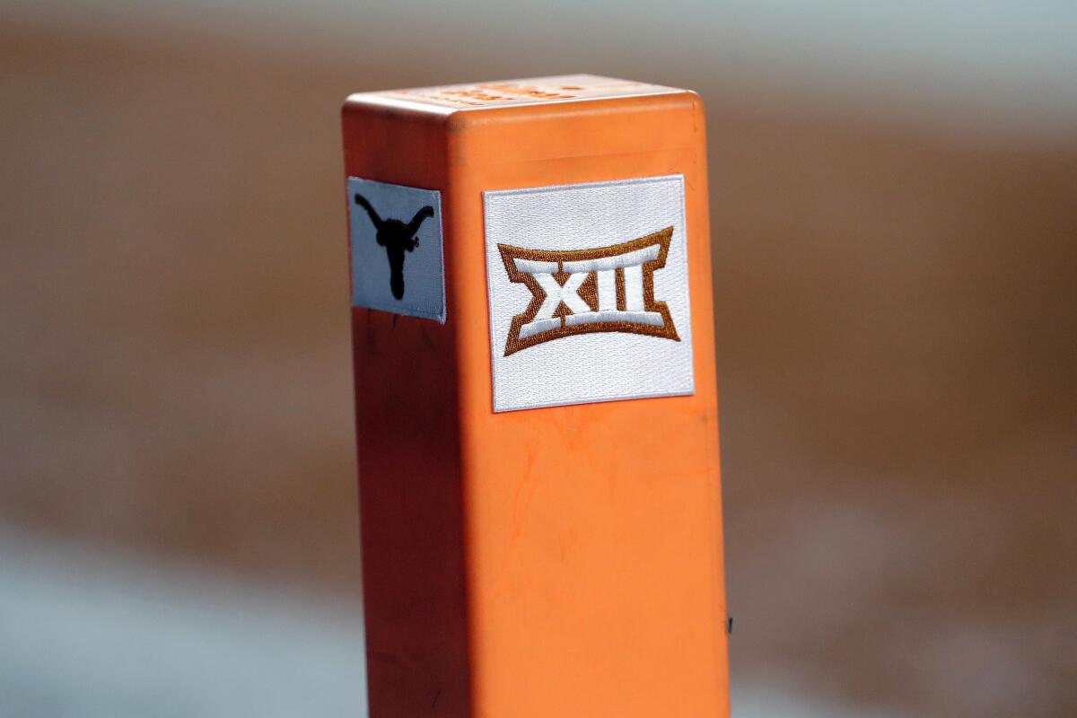 The Big 12 conference and Texas logos are seen on a pylon during a game.