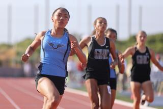 Carson High sophomore Christina Gray, left, wins the 100-meter dash at the City Section track and field championships