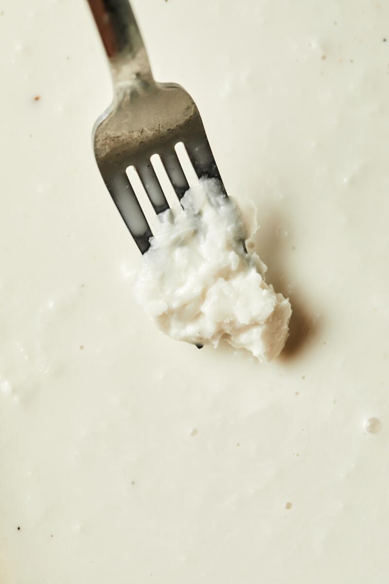 A fork scoops up coconut shaved ice