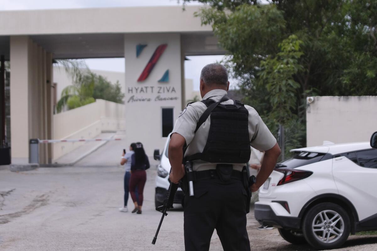 Mexican government forces guard the entrance of a hotel 