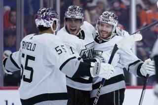 Los Angeles Kings' Quinton Byfield, from left, Anze Kopitar and Matt Roy celebrate.
