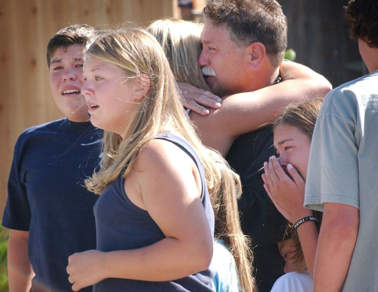 Brian Wofford, rejoices with his children on June 30, 2004, after arriving at their Encinitas home following a surprise weeklong remodel that quadrupled their house in size on the ABC television series "Extreme Makever: Home Edition."