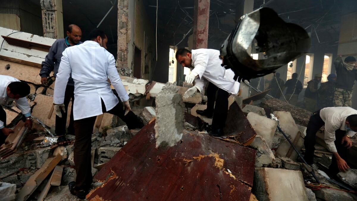 Medics search for bodies under the rubble of a funeral hall that was targeted by a Saudi-led coalition airstrike in Sanaa, Yemen, on Oct. 8.