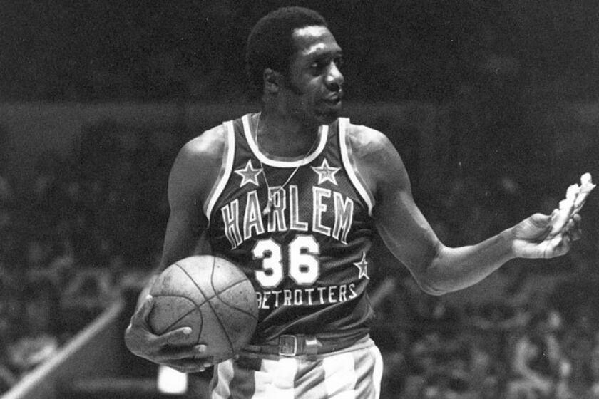 Meadowlark Lemon offers a pretzel to a referee during a Harlem Globetrotters game in 1978.