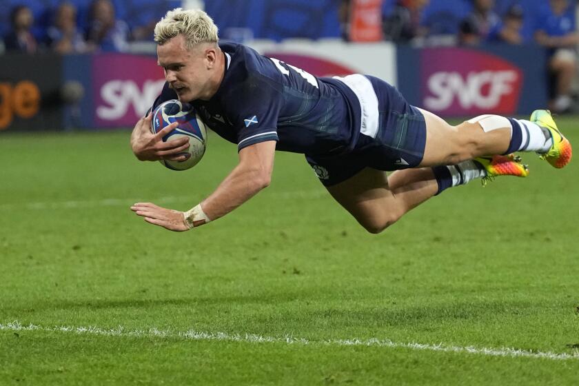 Scotland's Darcy Graham scores a try during the Rugby World Cup Pool B match between Scotland and Tonga at the Stade de Nice, in Nice, Sunday, Sept. 24, 2023. (AP Photo/Pavel Golovkin)