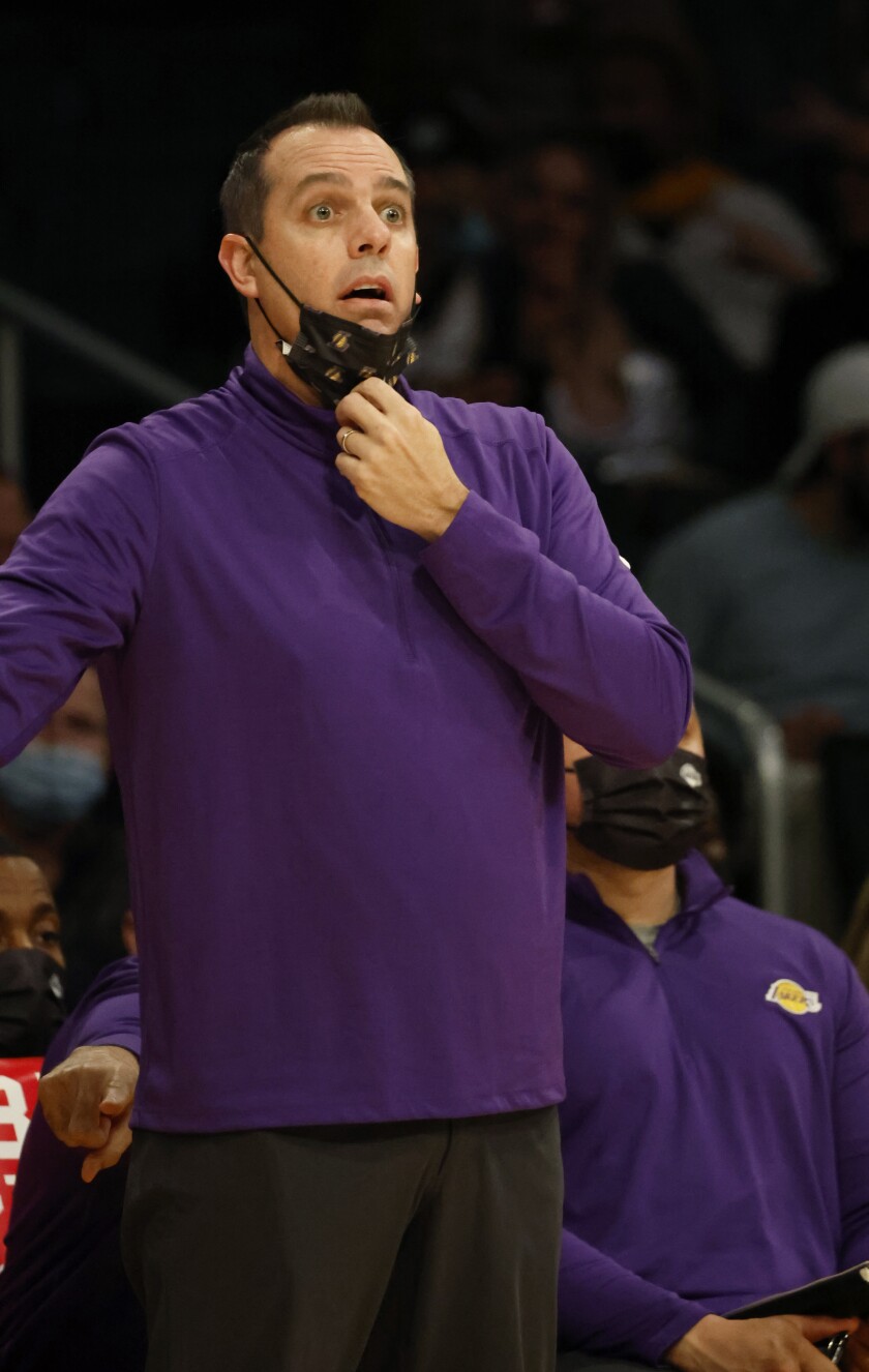 Lakers coach Frank Vogel drops his mask to yell plays to his team against the Indiana Pacers.