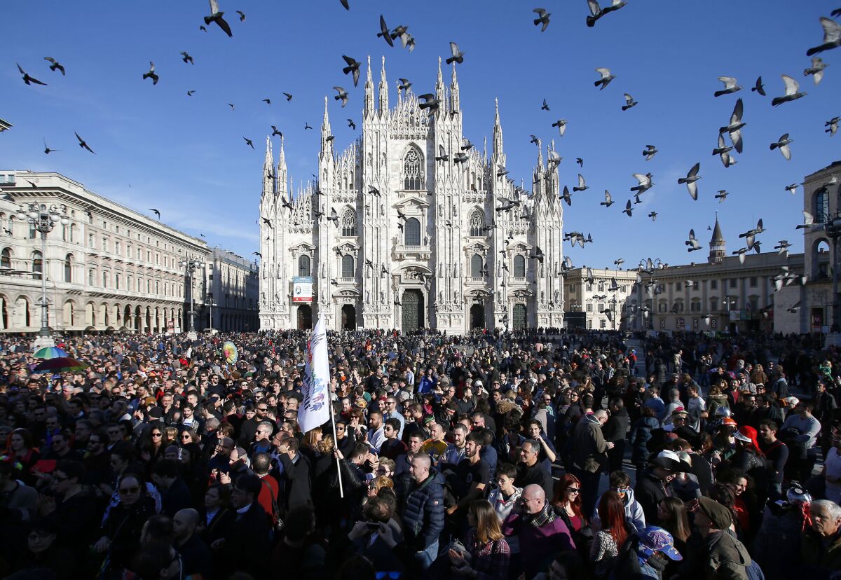 Demonstrators gather in front of Milan's Duomo cathedral for a gay rights rally before a vote in the Italian Parliament to change laws on recognizing same-sex couples.